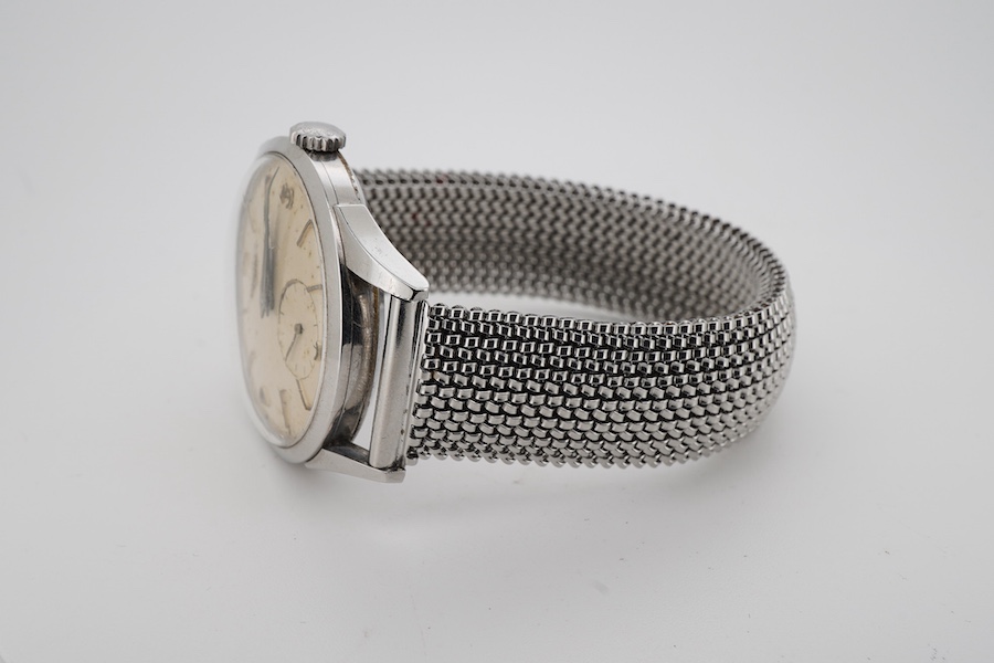 A gentleman's stainless steel Longines manual wind wrist watch, with baton and quarterly Arabic numerals and subsidiary seconds, case diameter 35mm, on an associated flexible strap.